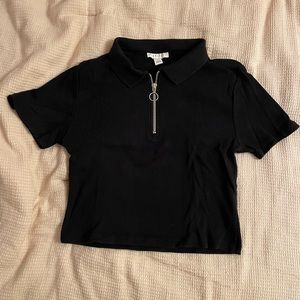 Medium, cropped, black t-shirt with a quarter zip and a collar